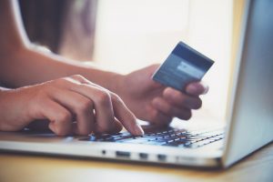 Hands,Holding,Credit,Card,And,Using,Laptop.,Online,Shopping